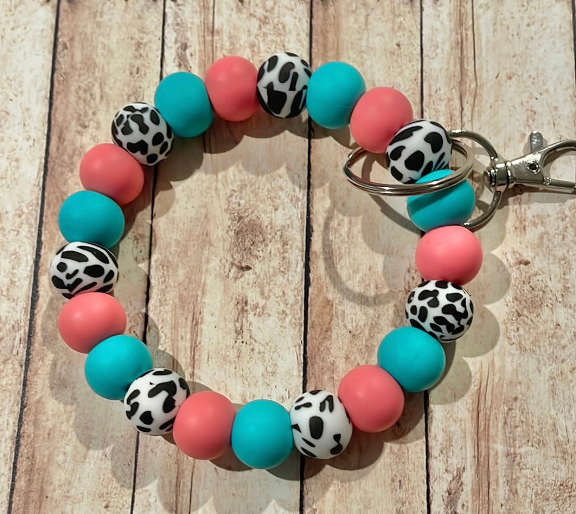 Pink/teal cow wristlet